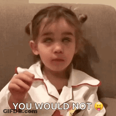 A Little Girl Is Sitting On A Couch With Her Eyes Closed And Making A Funny Face . GIF