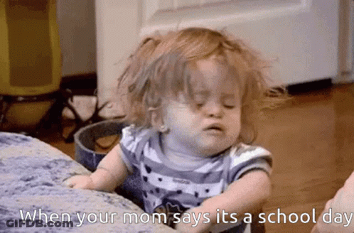 A Little Girl Is Sitting On A Couch With The Words When Your Mom Says It 'S A School Day GIF