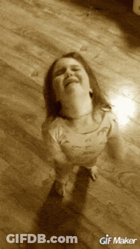 A Little Girl Is Sitting On A Wooden Floor With A Gif Maker Watermark GIF