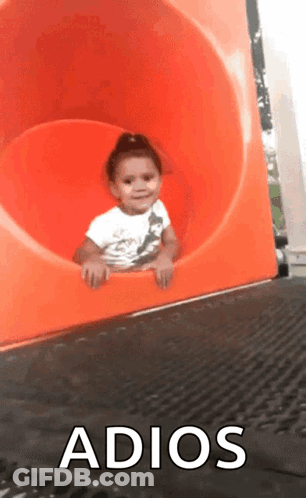 A Little Girl Is Sliding Down An Orange Slide With The Words Adios Written On The Bottom GIF