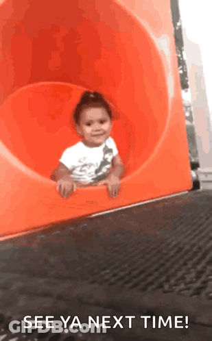 A Little Girl Is Sliding Down An Orange Slide With The Words See Ya Next Time GIF