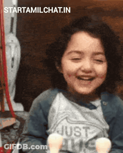 A Little Girl Is Smiling And Wearing A Shirt That Says Just Love GIF