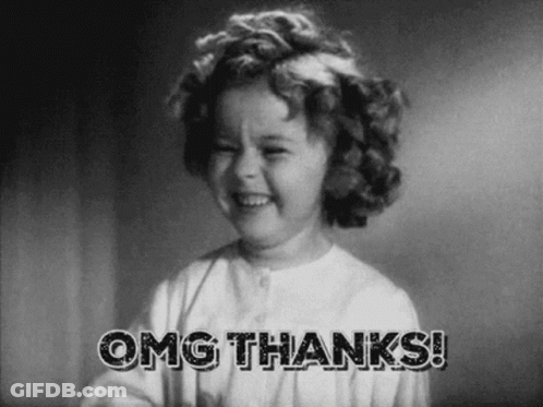 A Little Girl Is Smiling In A Black And White Photo With The Words `` Omg Thanks '' . GIF