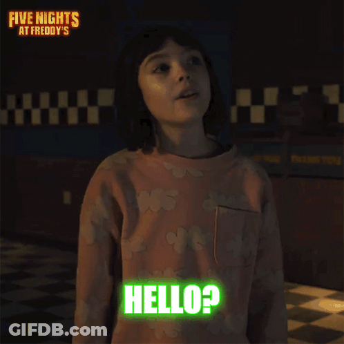 A Little Girl Is Standing In A Dark Room And Says Hello ? GIF
