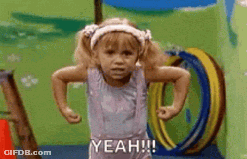 A Little Girl Is Standing In A Playground With Her Hands On Her Hips And Saying `` Yeah '' . GIF