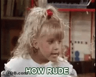 A Little Girl Is Standing In Front Of A Toy Box And Says `` How Rude '' . GIF