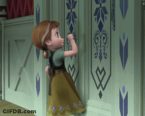 A Little Girl Is Standing In Front Of A Wall With A Geometric Design GIF