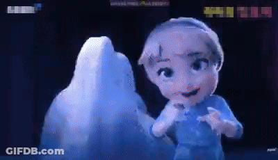 A Little Girl Is Standing In Front Of An Ice Sculpture GIF