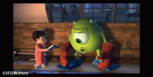 A Little Girl Is Standing Next To A Green Monster GIF