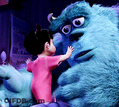 A Little Girl Is Standing Next To A Monster From Monsters Inc. GIF
