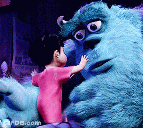 A Little Girl Is Standing Next To A Monster From The Movie Monsters Inc GIF