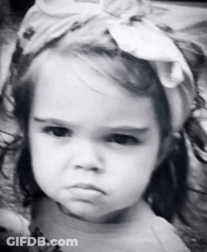 A Little Girl Is Wearing A Headband And Making A Funny Face GIF