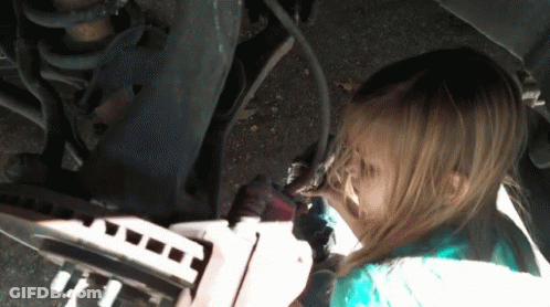 A Little Girl Is Working On A Car And Has A Dirty Face GIF