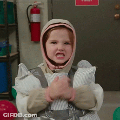 A Little Girl Is Wrapped In Duct Tape And Has A Hood On Her Head GIF