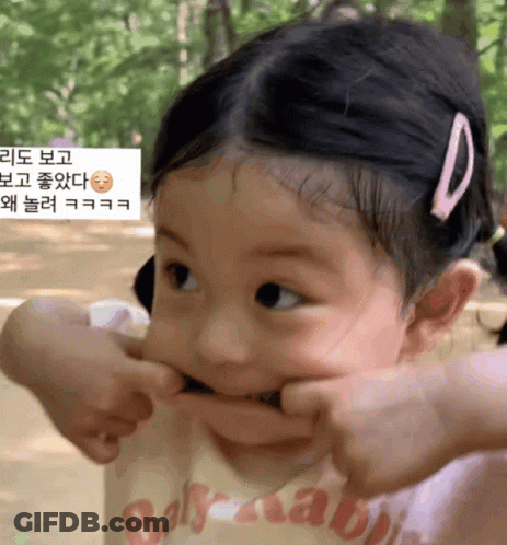 A Little Girl Making A Funny Face Wearing A Shirt That Says Baby Rabbit GIF
