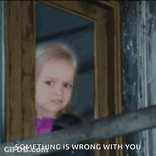 A Little Girl Peeking Out Of A Door With The Words Something Is Wrong With You Written Below Her GIF