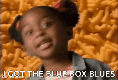 A Little Girl Says I Got The Blue Box Blues In Front Of A Pile Of Macaroni Cheese GIF