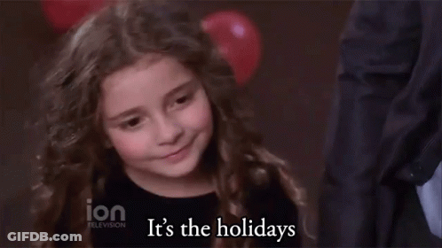 A Little Girl Says It 'S The Holidays In Front Of A Balloon GIF