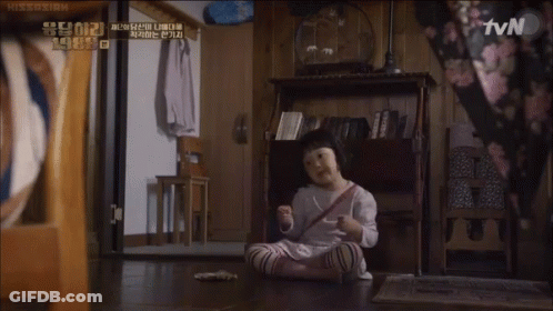 A Little Girl Sits On The Floor In Front Of A Tv Screen GIF