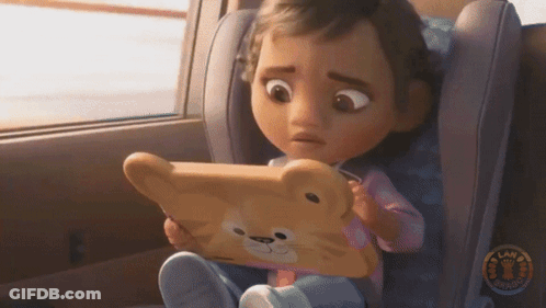 A Little Girl Sitting In A Car Seat Looking At A Tablet GIF