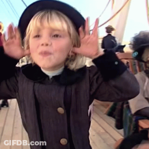 A Little Girl Wearing A Black Hat And A Black Coat GIF