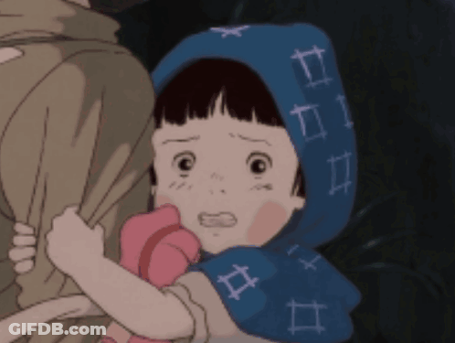 A Little Girl Wearing A Blue Scarf With Numbers On It Is Being Held By A Person GIF