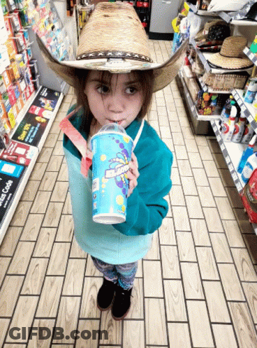A Little Girl Wearing A Cowboy Hat Drinks From A Cup That Says ' Slush ' On It GIF