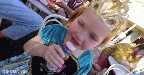 A Little Girl Wearing A Crown Holds A Bottle GIF