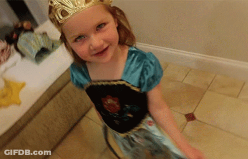 A Little Girl Wearing A Dress And A Crown GIF