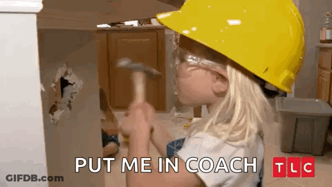 A Little Girl Wearing A Hard Hat And Safety Glasses Is Holding A Hammer In Front Of A Wall . GIF