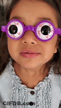 A Little Girl Wearing A Pair Of Purple Glasses With Fake Eyes GIF