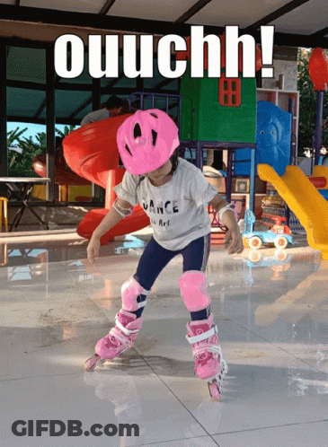 A Little Girl Wearing A Pink Helmet Is Rollerblading With The Words Ouuchh Behind Her GIF