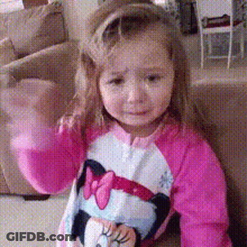 A Little Girl Wearing A Pink Minnie Mouse Shirt GIF