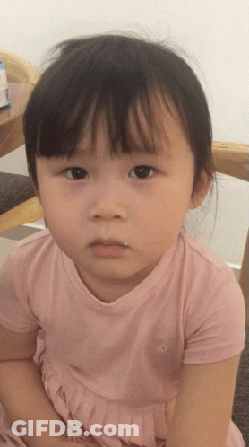A Little Girl Wearing A Pink Shirt With A Penguin On The Front GIF