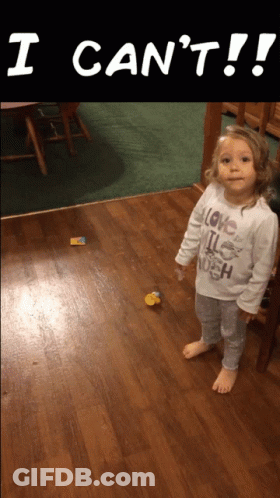 A Little Girl Wearing A Shirt That Says I Love It Enough Is Standing On A Wooden Floor GIF