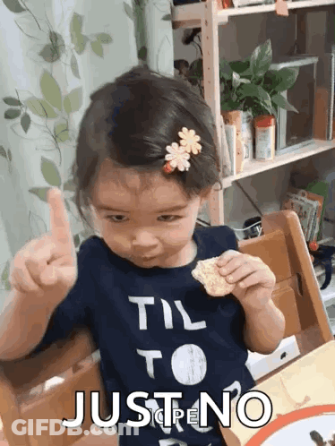 A Little Girl Wearing A Shirt That Says " Til To Just No " GIF