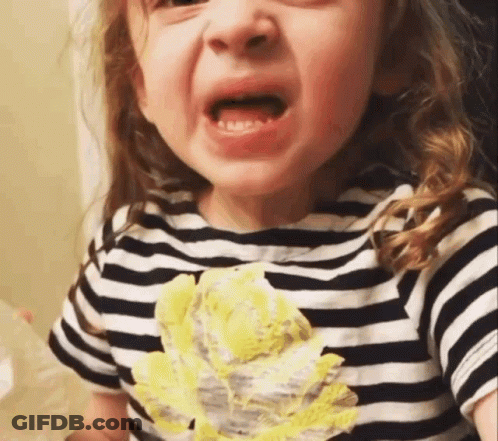 A Little Girl Wearing A Striped Shirt With A Yellow Flower On The Front Is Crying GIF