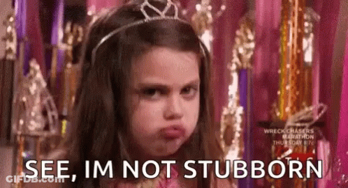 A Little Girl Wearing A Tiara Is Making A Funny Face . GIF