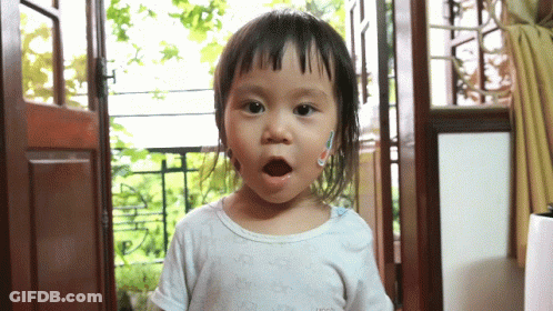 A Little Girl Wearing A White Shirt That Says ' Gucci ' On It GIF