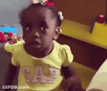 A Little Girl Wearing A Yellow Gap Shirt Is Making A Face . GIF