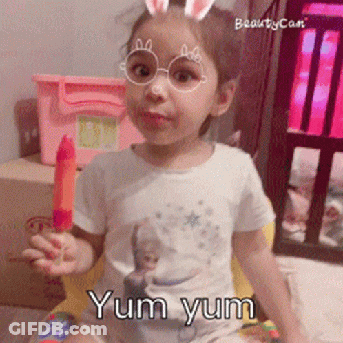 A Little Girl Wearing Glasses And Bunny Ears Is Holding A Popsicle And The Words Yum Yum Are Below Her GIF