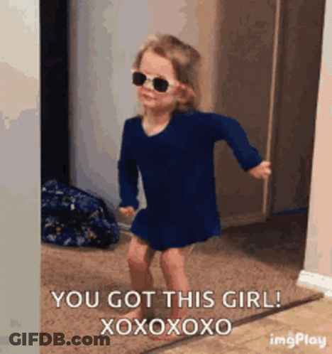 A Little Girl Wearing Sunglasses And A Blue Dress Is Dancing In A Room . GIF