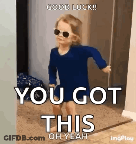 A Little Girl Wearing Sunglasses And A Blue Shirt Is Running In A Doorway . GIF