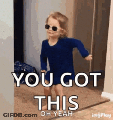 A Little Girl Wearing Sunglasses And A Blue Shirt Is Walking In A Doorway . GIF