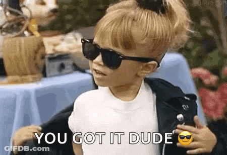 A Little Girl Wearing Sunglasses And A Leather Jacket Is Standing Next To A Table And Says `` You Got It Dude '' . GIF