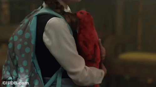 A Little Girl With A Backpack Is Holding A Stuffed Animal GIF