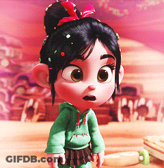 A Little Girl With A Bun And Sprinkles On Her Hair Is Wearing A Green Hoodie GIF