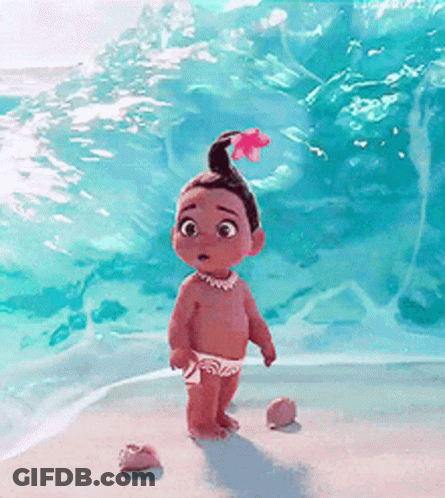 A Little Girl With A Flower In Her Hair Is Standing On A Beach . GIF