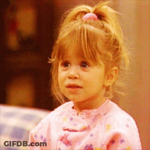 A Little Girl With A Pink Ponytail Is Wearing A Pink Shirt GIF