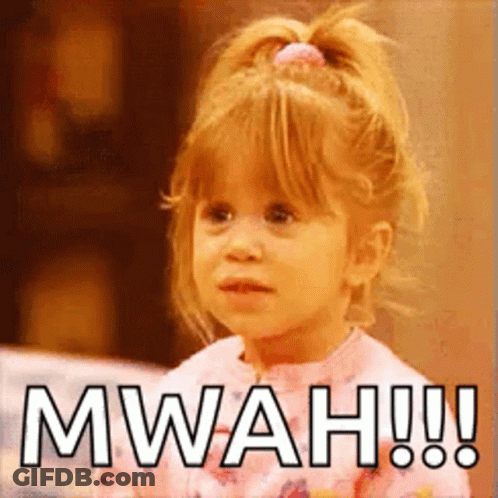A Little Girl With A Ponytail Is Making A Funny Face And Saying Mwah ! GIF